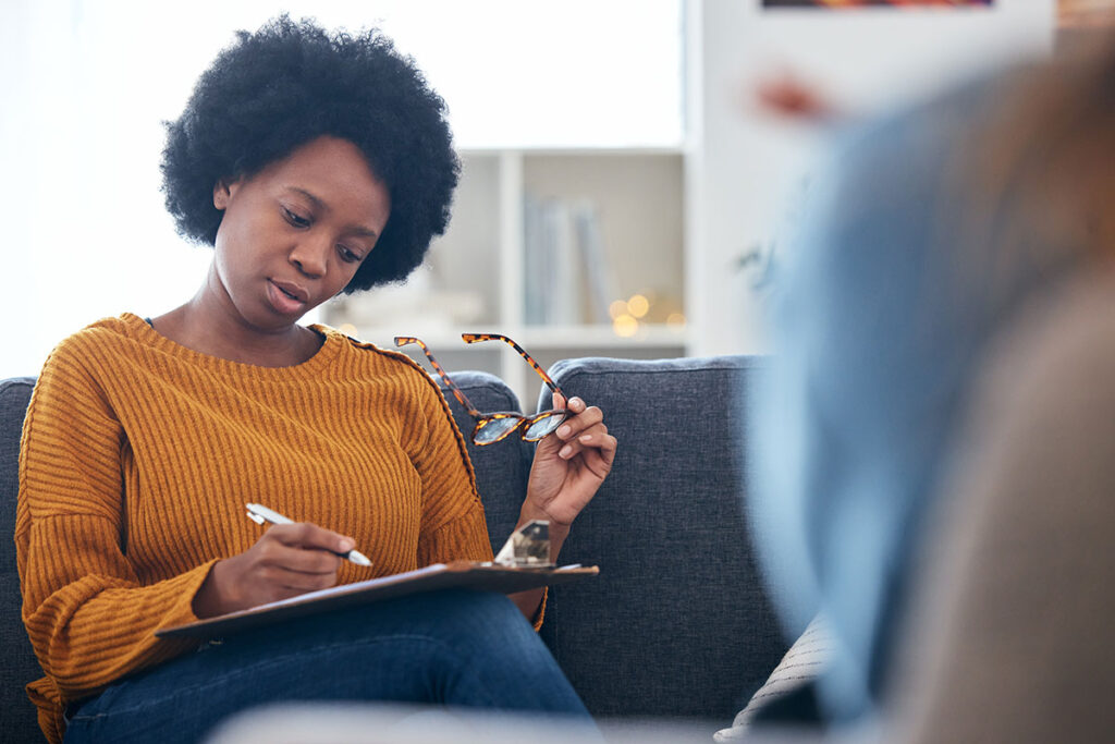 Female therapist in session with unrecognizable patient