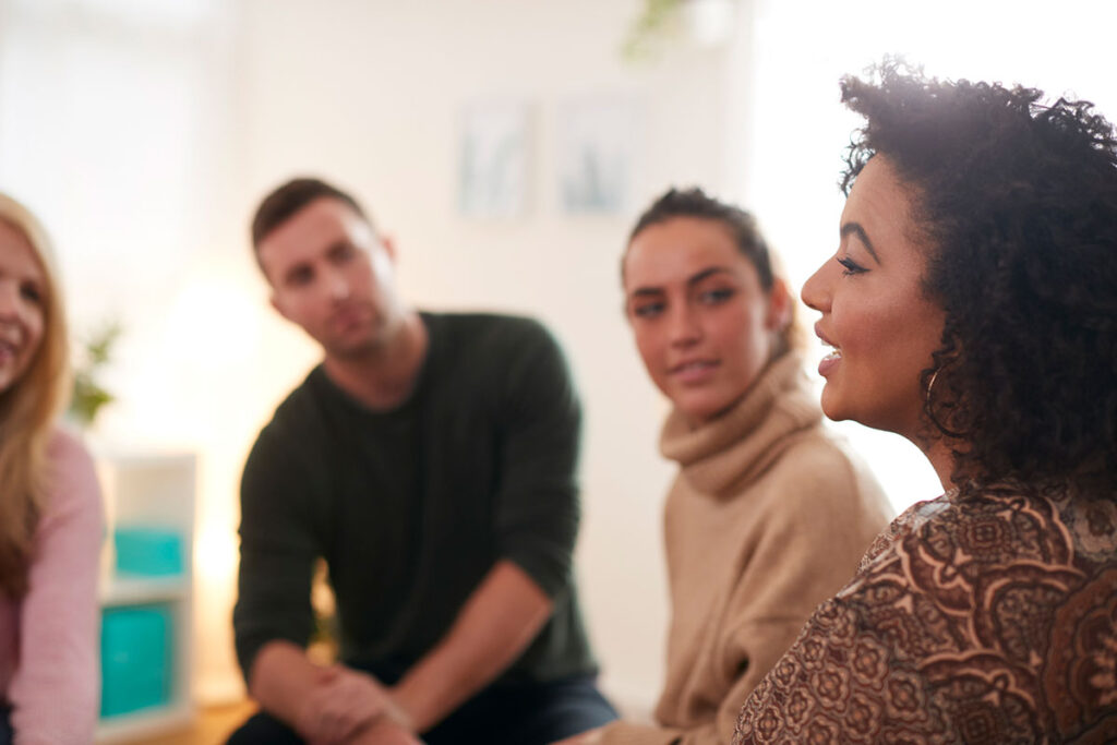 Woman speaking in a group setting