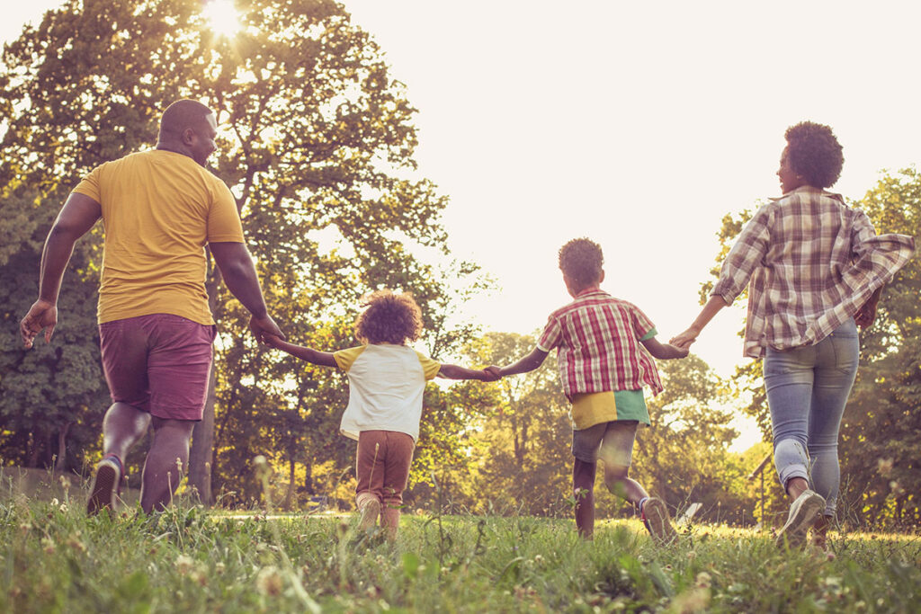 Happy family running in a field