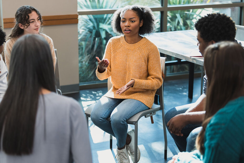Woman speaking in a group setting