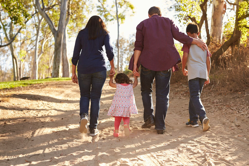 Family walking on a path in the sun